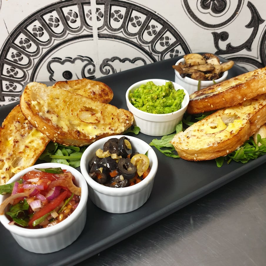Toasted bread with guacamole, olive tapenade, salsa and mushrooms
