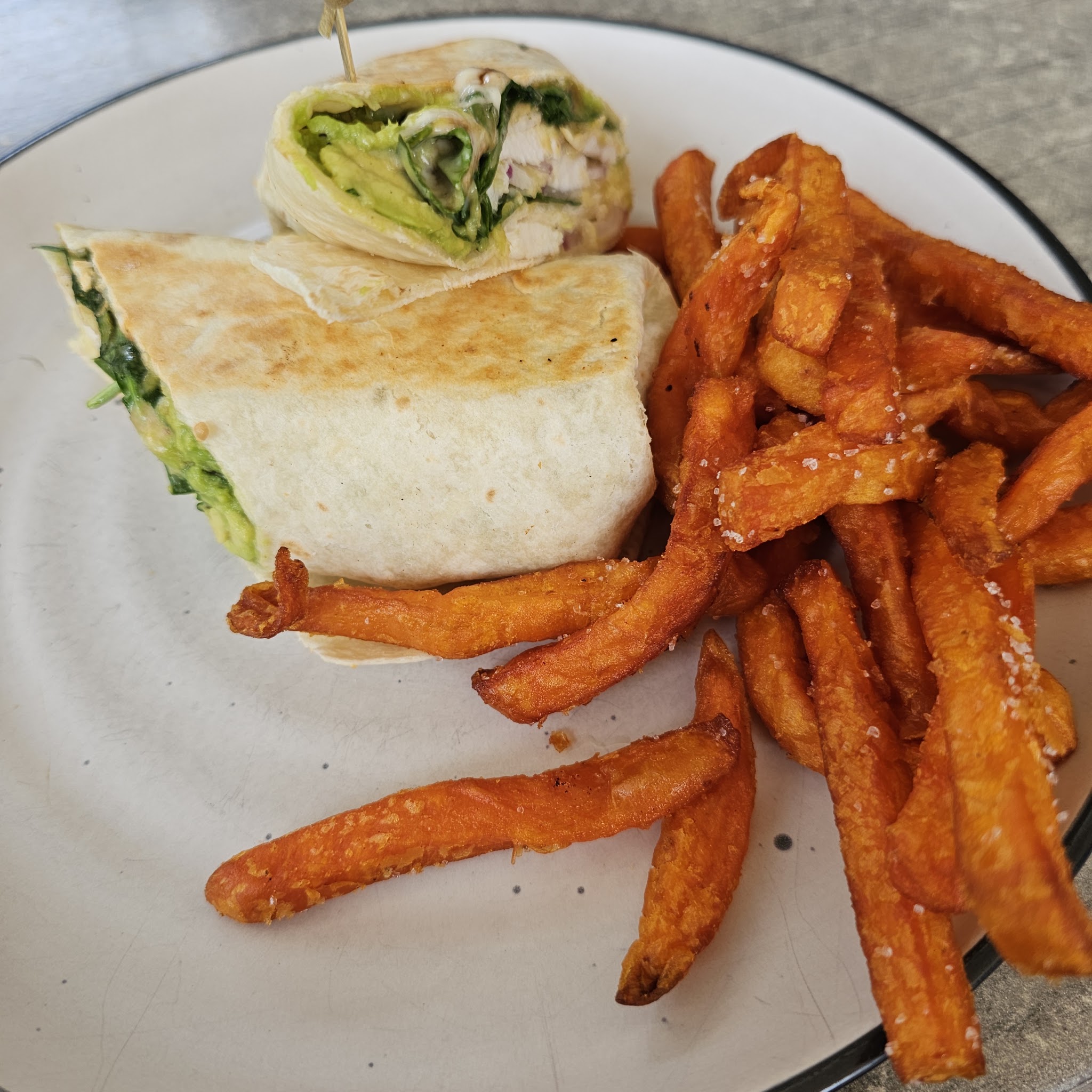 Toasted chicken and avocado wrap with sweet potato fries